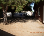 Side yard with large RV gate and huge shade trees